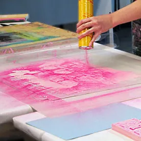 A Worker At X Athletic Wear Industries Doing Flock Screen Printing Methods