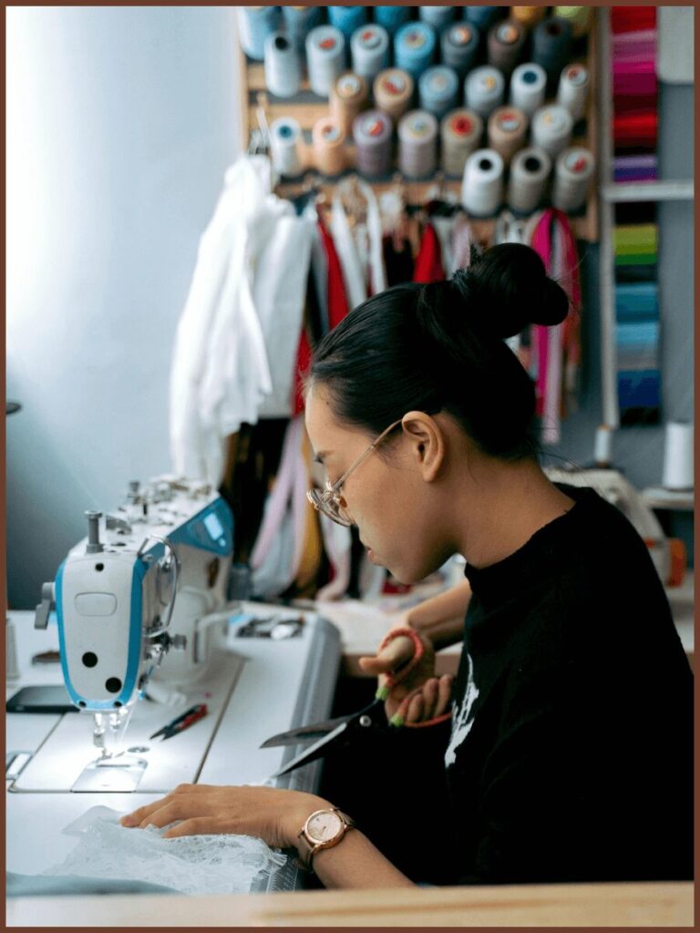 A Picture Of Young Lady During Cutting And Sewing At X Athletic Wear The Leading Private Label Clothing Manufacturer In USA.