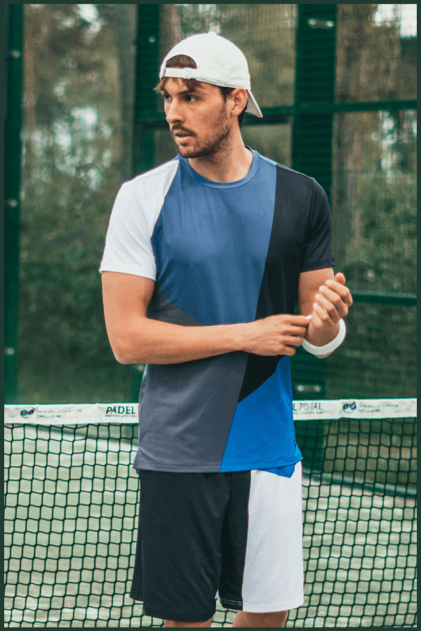 Young Man Posing In Quality Athletic Shirt Manufactured By The Best Athletic Wear Manufacturer